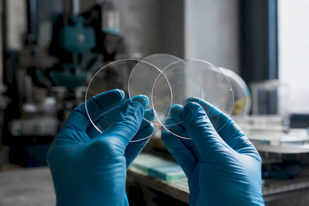 Close-up of technician holding heat-resistant glass samples