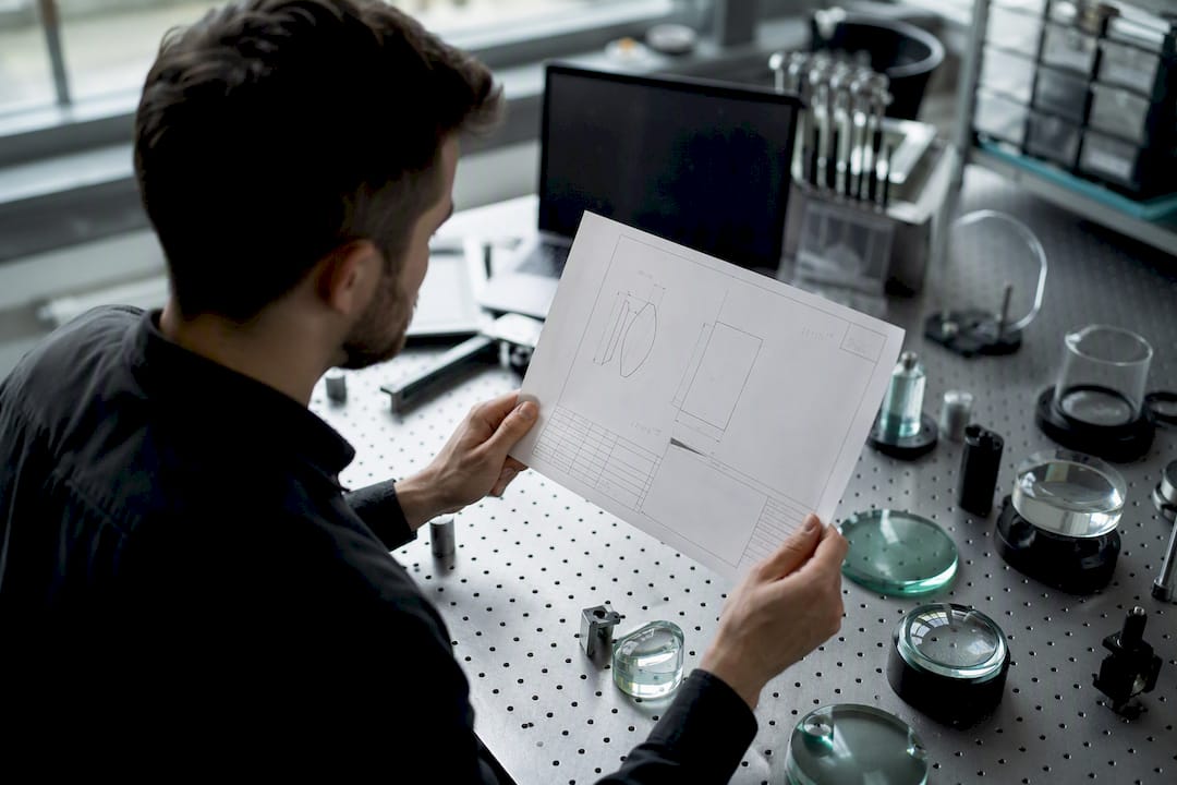 Technician verifying optical drawing table