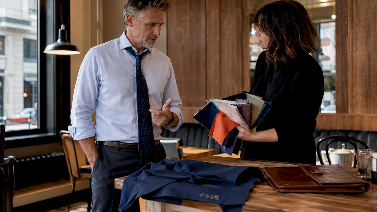 Agent consulting stylist on outfit colors