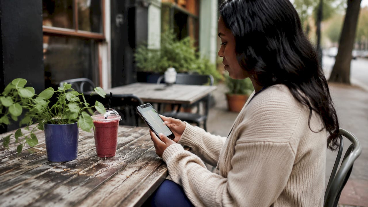 Hands holding smartphone with local map search visible