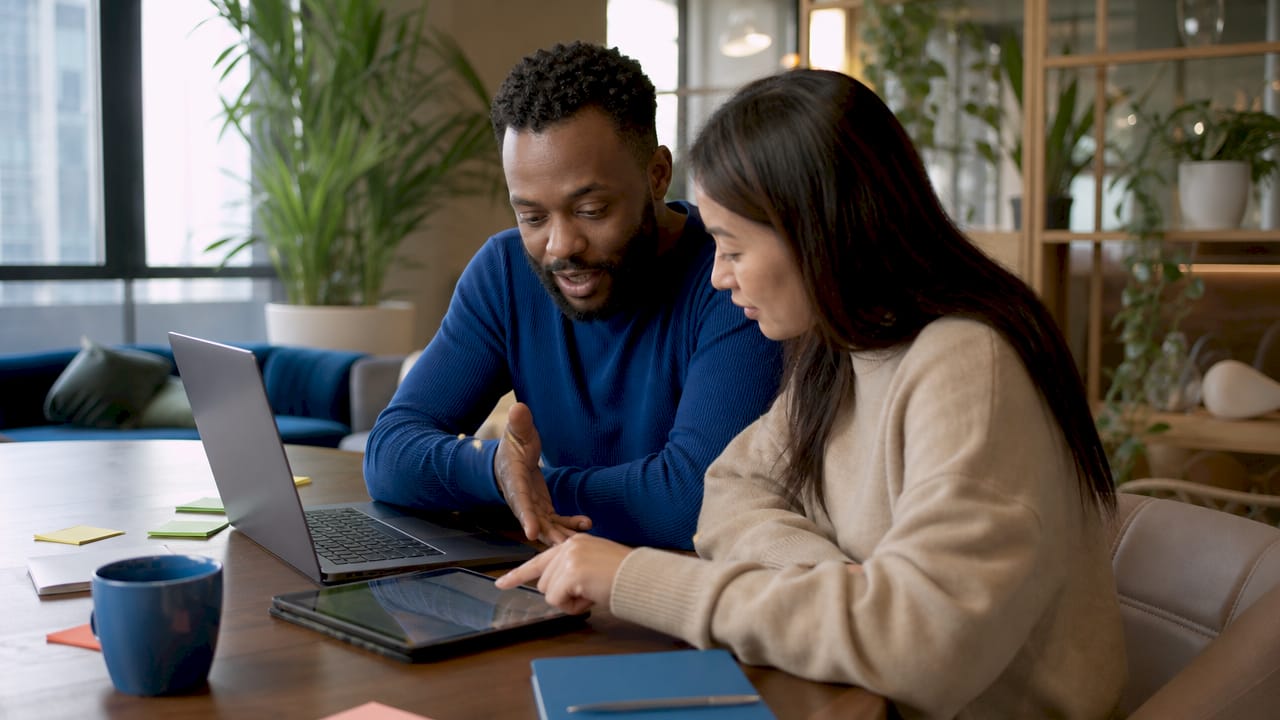 Two professionals collaborating on digital marketing