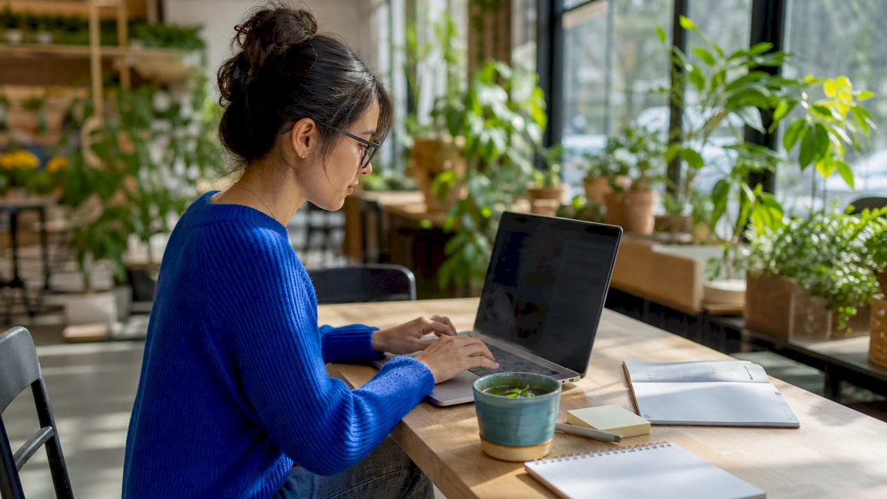 Hands typing on laptop with influencer SEO materials