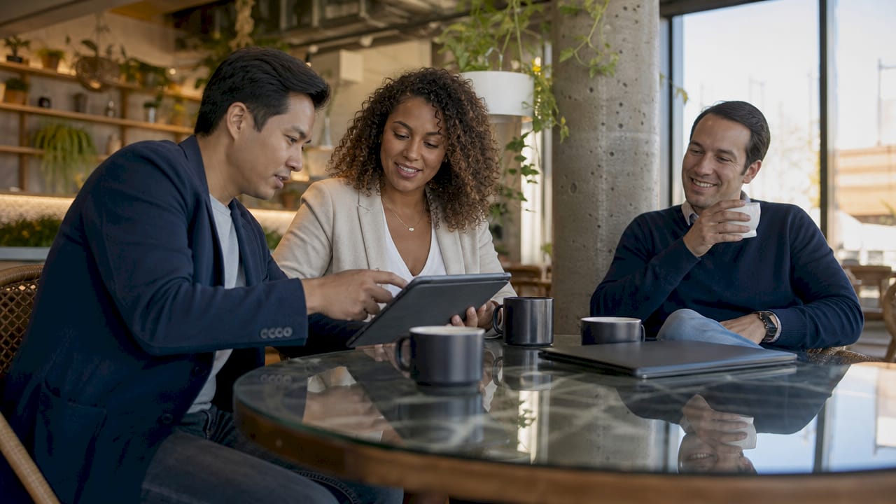 Three real estate agents collaborating indoors