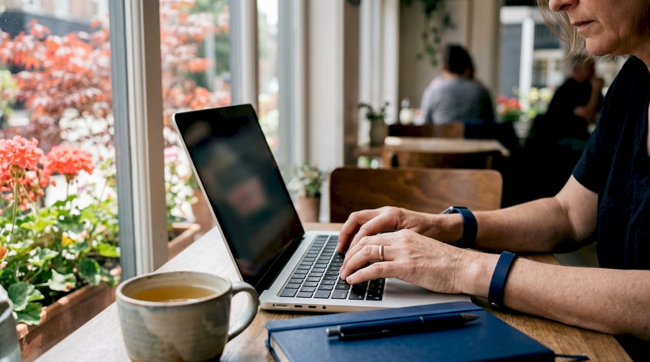 Close-up of hands typing on laptop