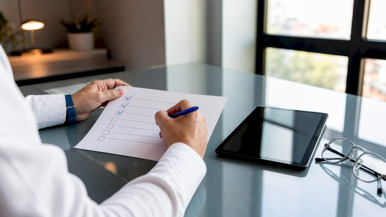 Hands checking local SEO checklist on desk