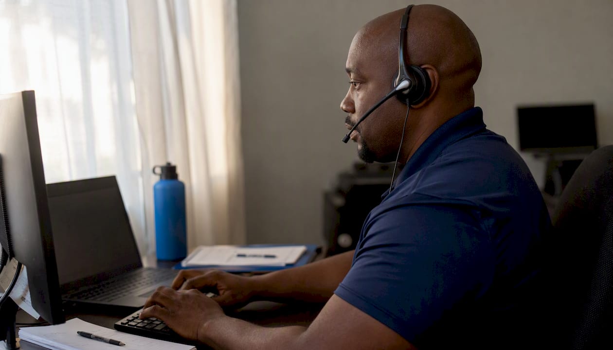 Dispatcher on headset managing leads in office