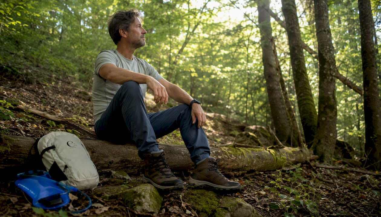 Hiker resting showing hiking boots in forest