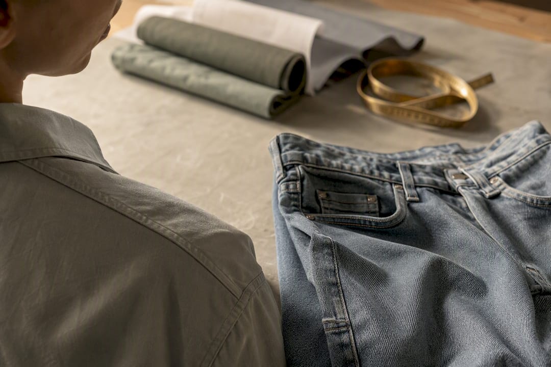 Close-up of shirt shoulder seam and relaxed fit jean waist