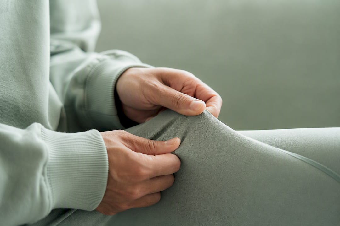 Close-up of breathable athleisure fabric touched by hands