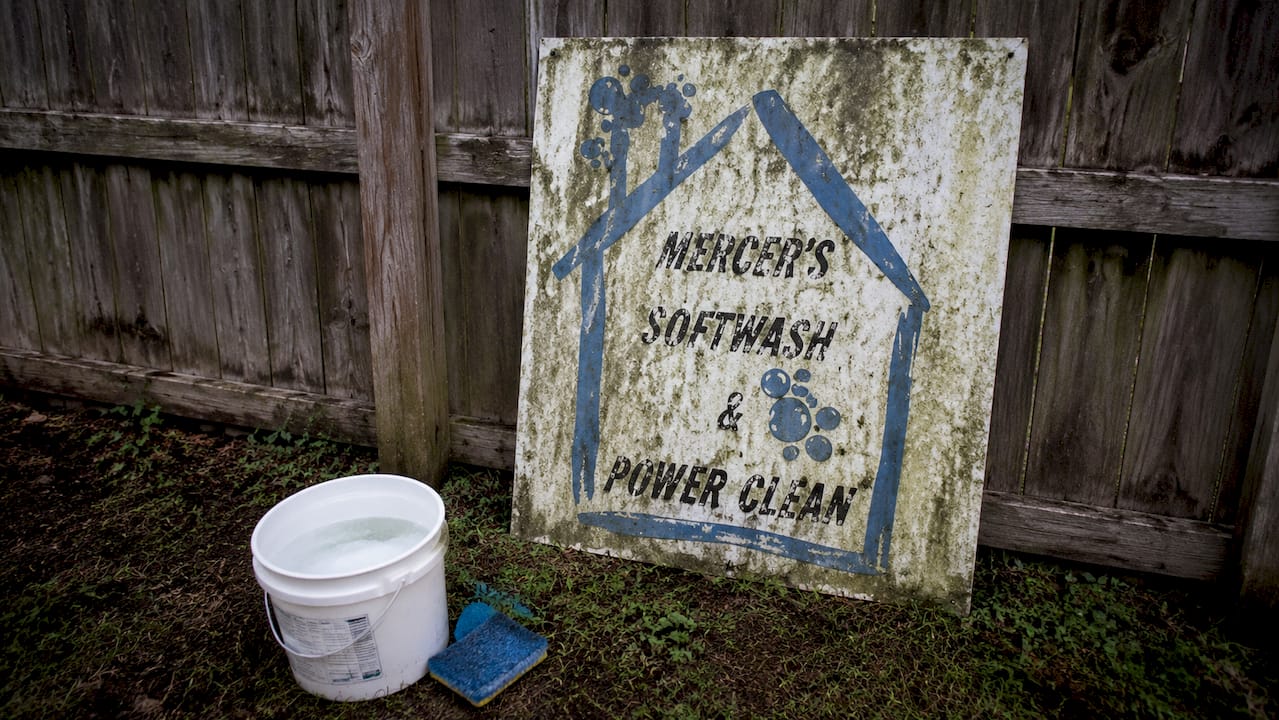 Exterior sign showing algae and peeling vinyl
