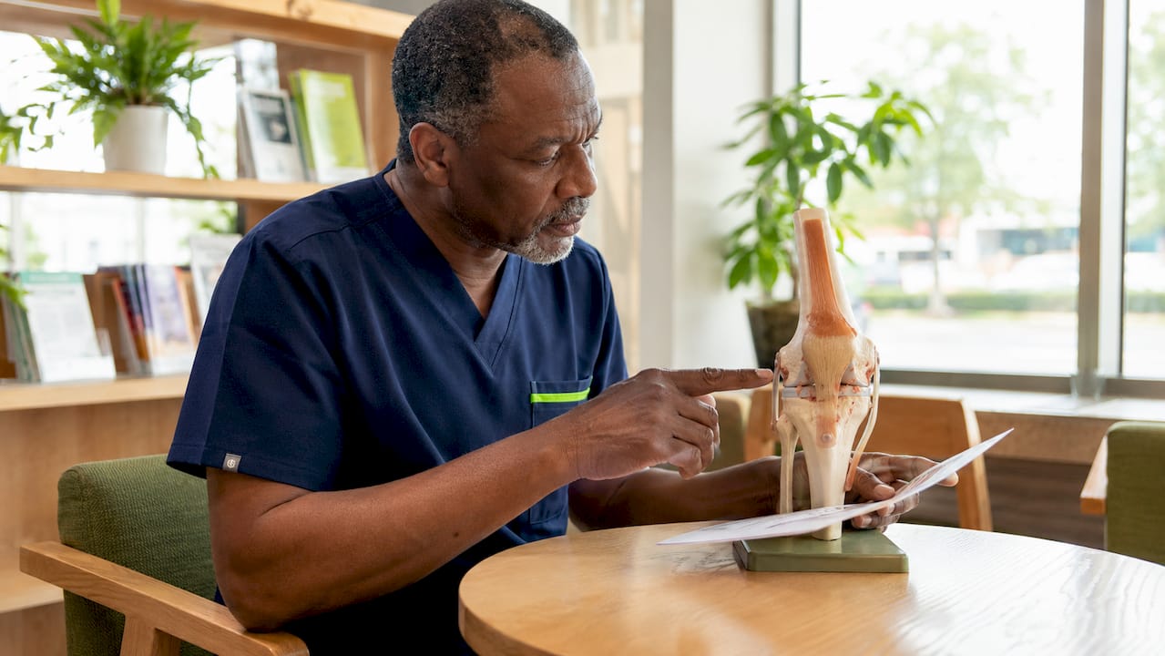 Doctor examining knee cartilage model
