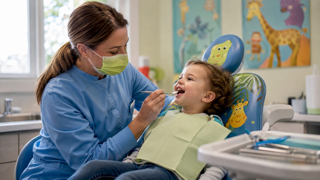 Dentist examining toddler's teeth