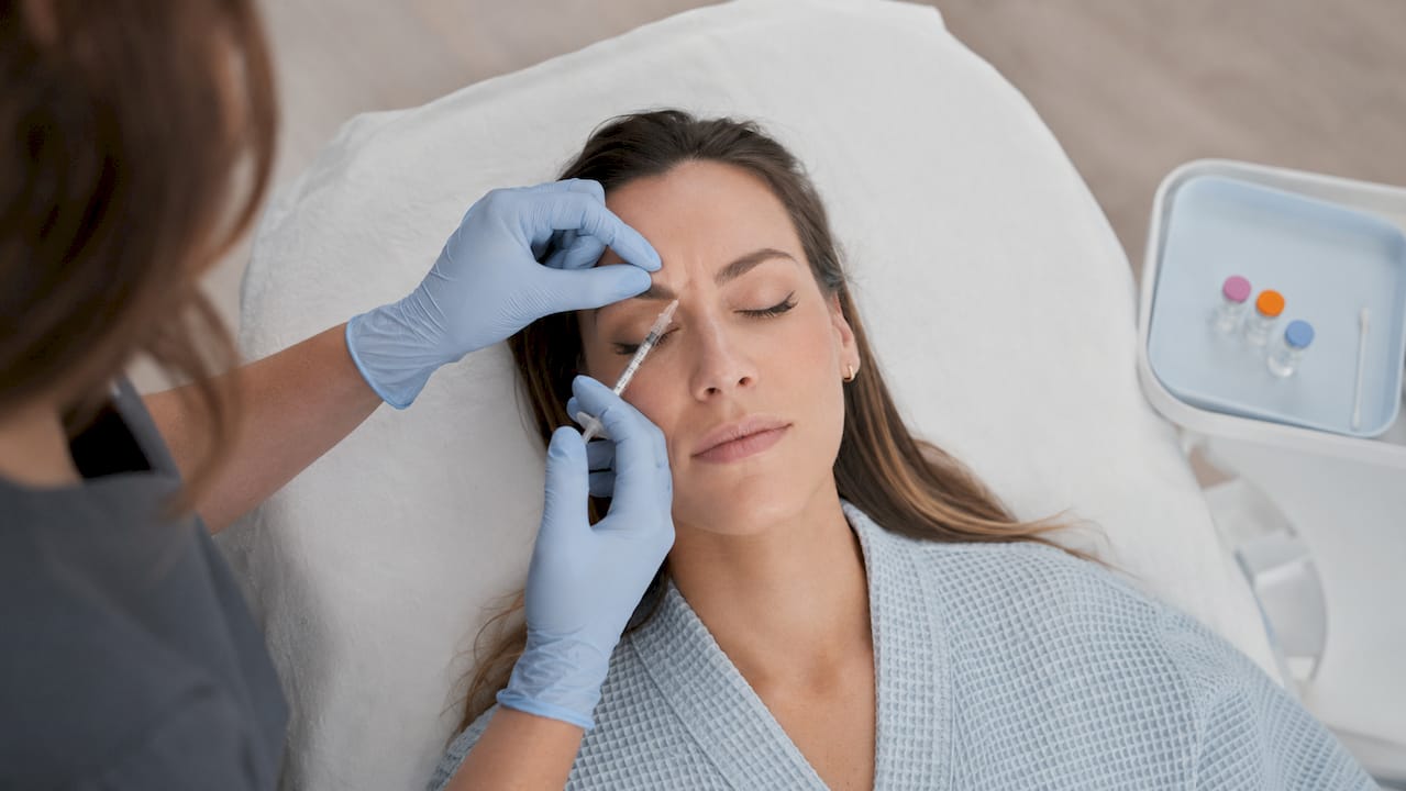 Healthcare professional injecting neuromodulator treatment