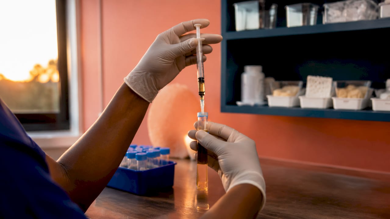 Hands preparing PRP injection in clinic