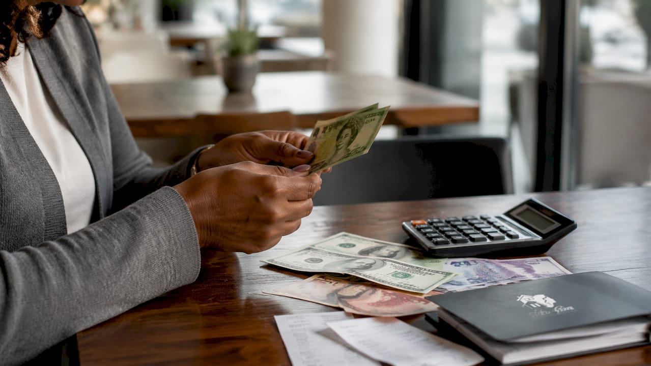 Woman handling Canadian currency and bank fees