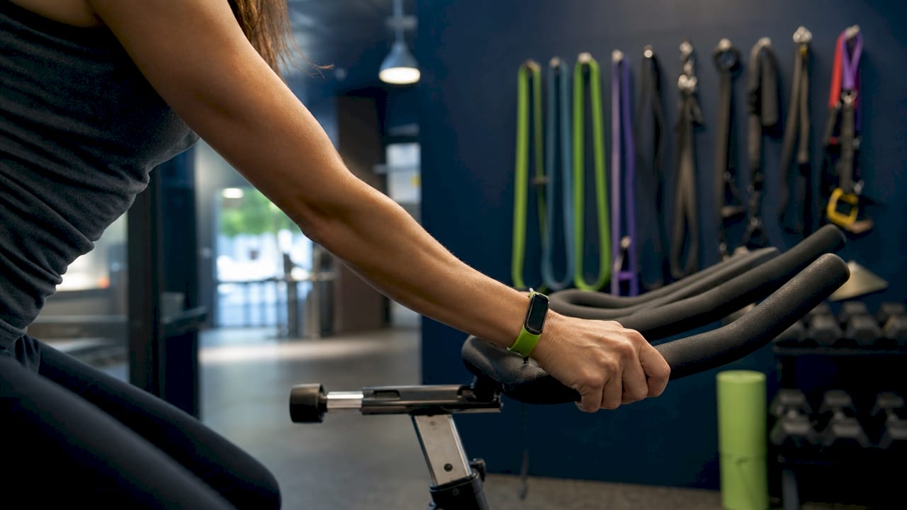 Hands on stationary bike handlebars exercising