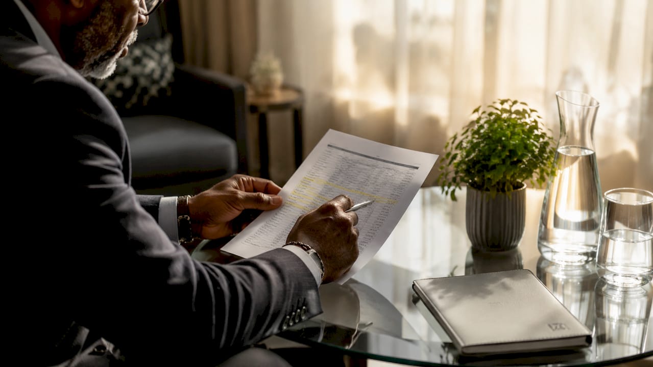 Hands pointing at agent registry document on desk