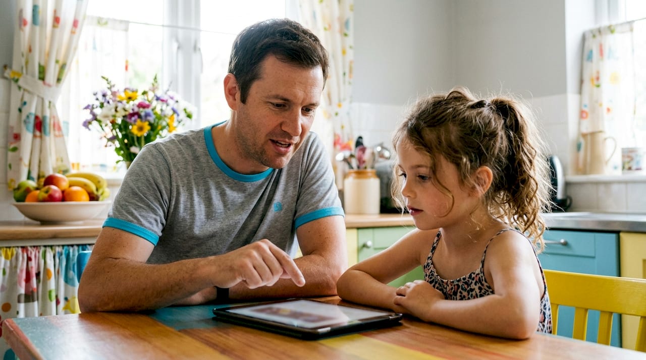 Father and daughter reviewing dental clinic online
