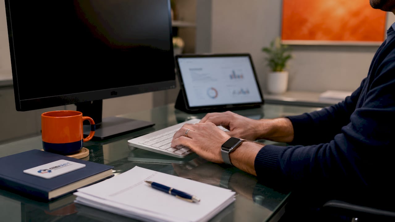 Hands typing on keyboard in clinical server room