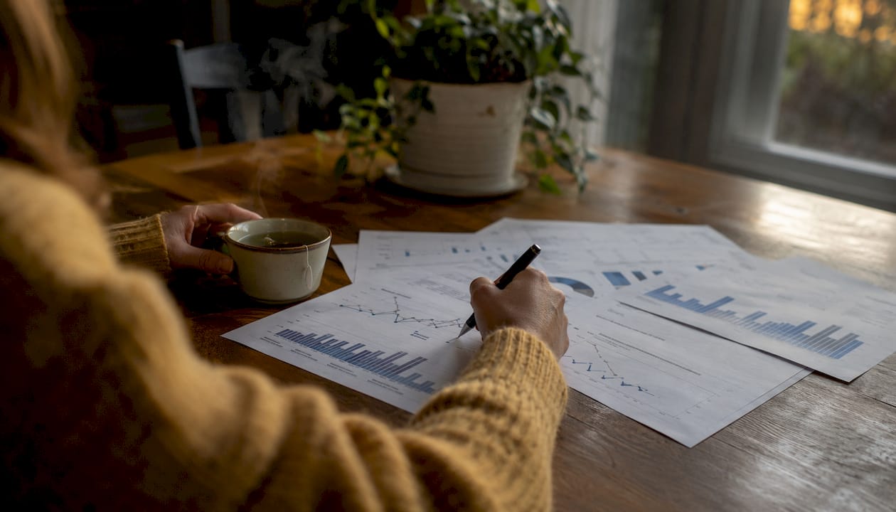 Hands reviewing economic charts for Southlake market