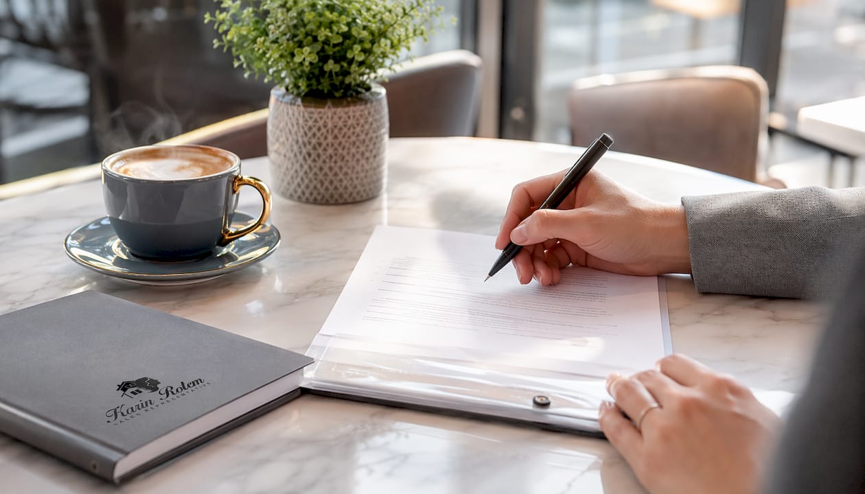Hands preparing real estate wire transfer documents