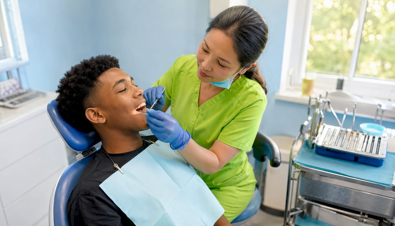 Dentist examining patient during dental checkup