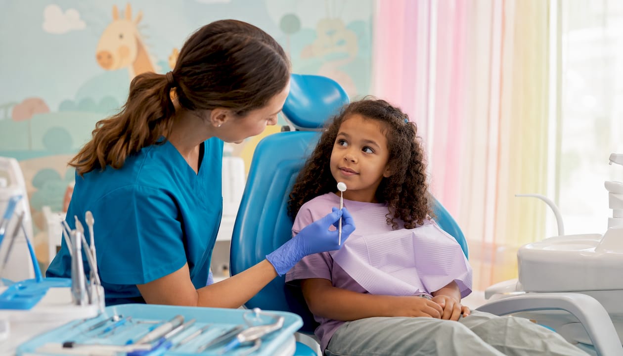Pediatric dentist calming anxious child