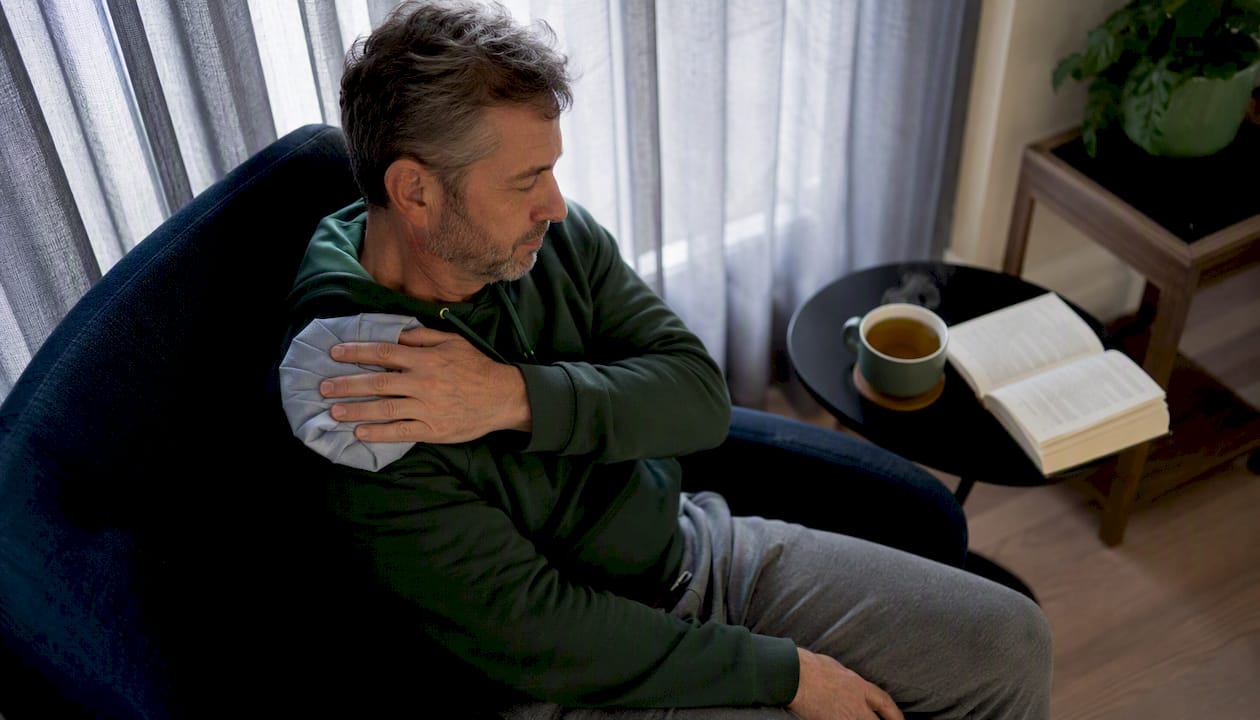 Man applying ice pack post injection