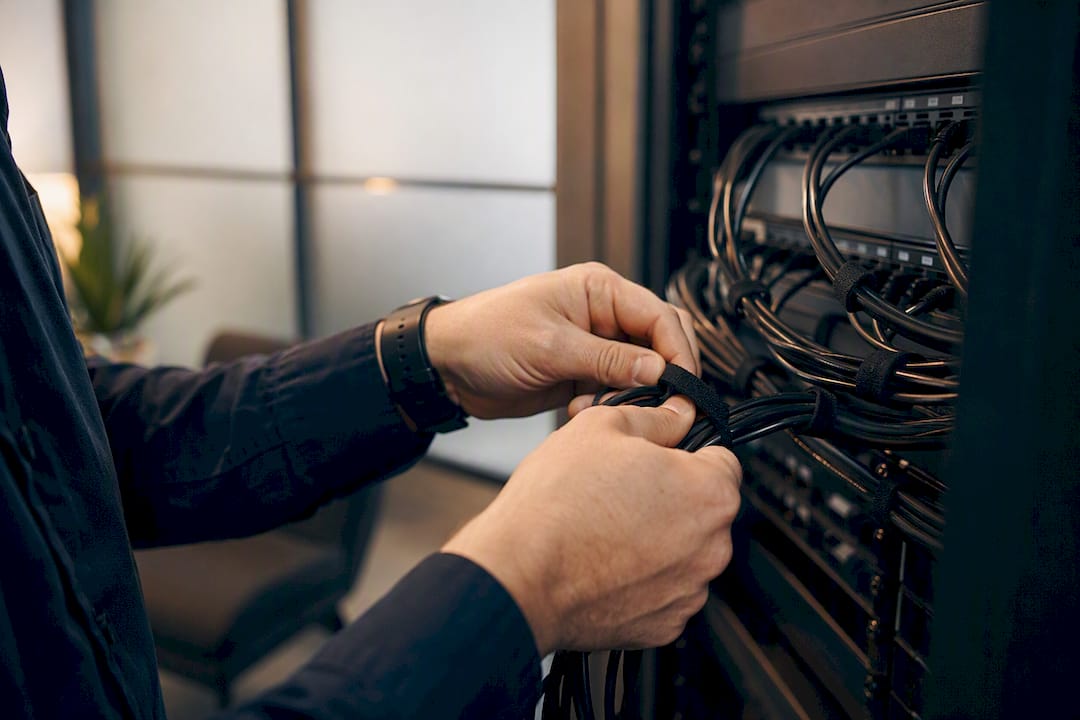 Hands installing call tracking cables