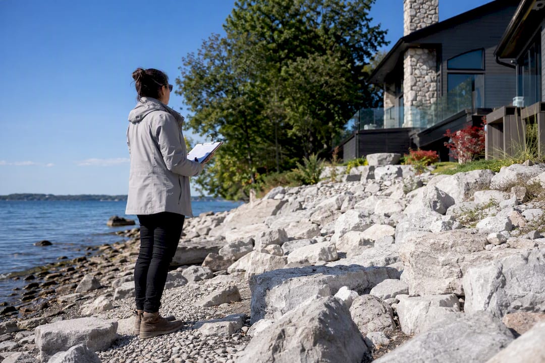 Appraiser inspecting waterfront property exterior
