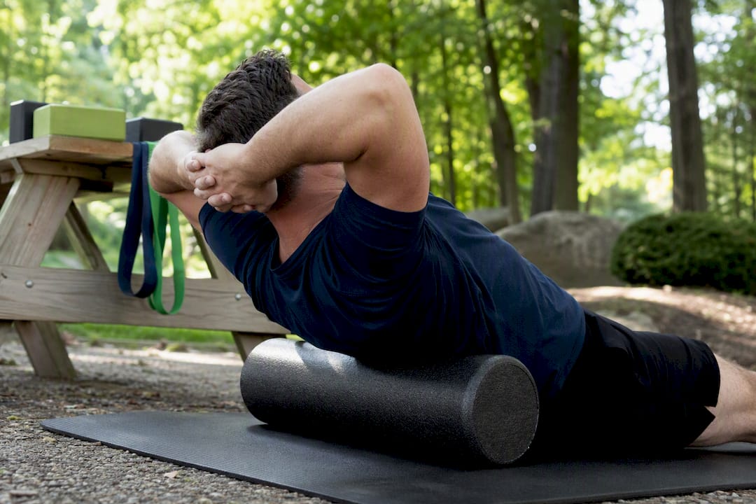 Patient doing thoracic extension exercise on foam roller