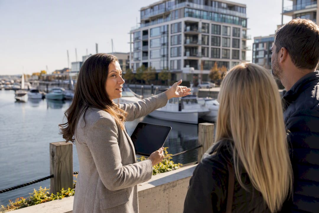 Agent showing waterfront condo exterior