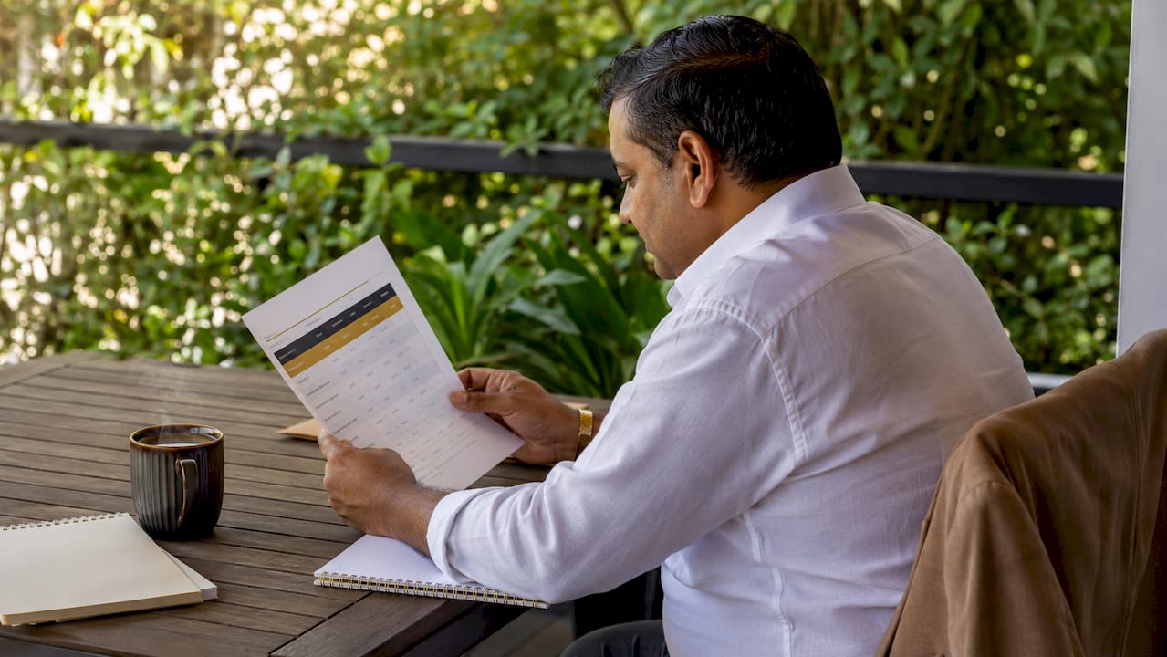 Man pointing at business loan interest rate chart