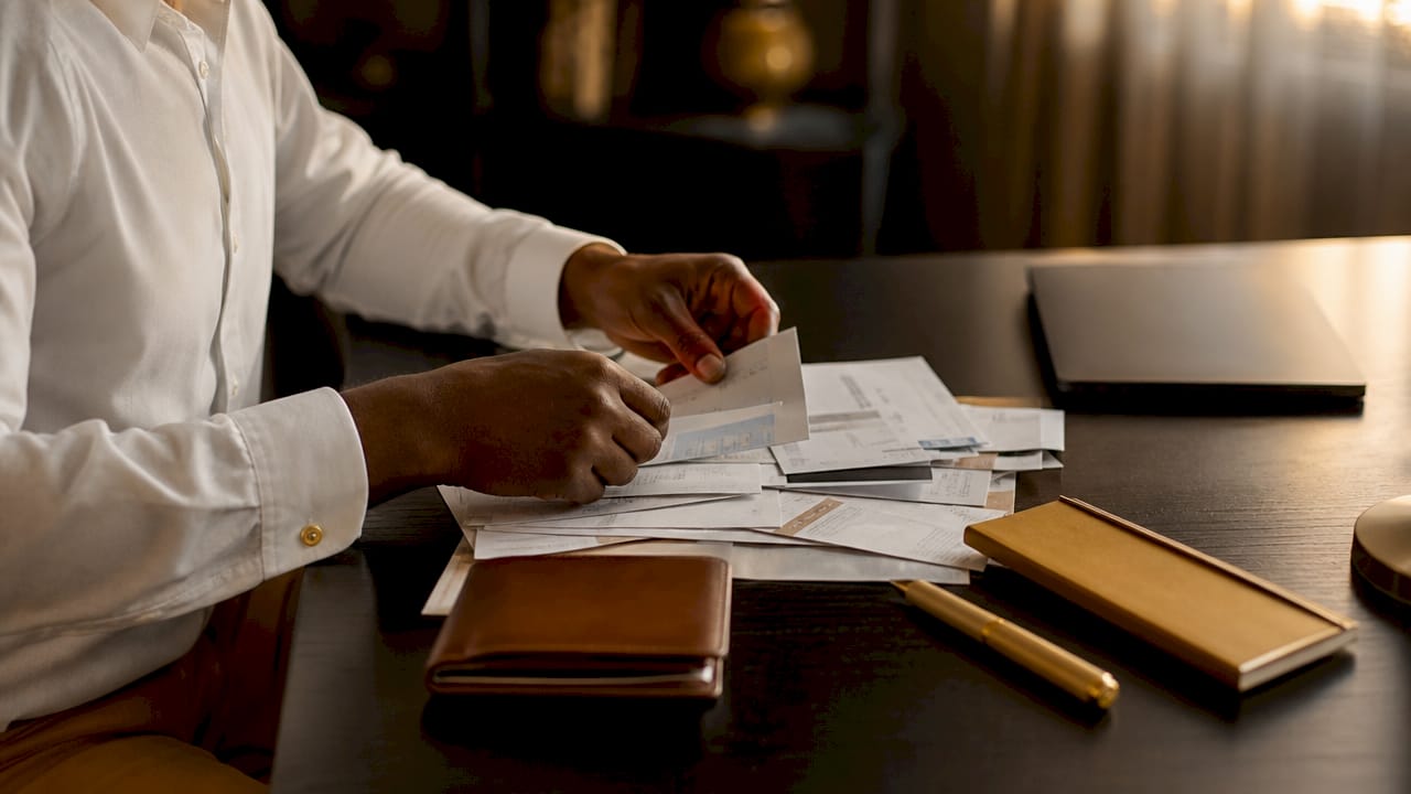 Hands sorting debt bills on office desk