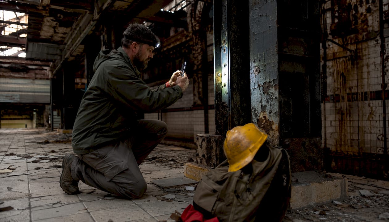 What Is Urban Exploration? Your Complete 2026 Guide 2026 Lizard's Lunch Man inspecting and photographing hospital interior details