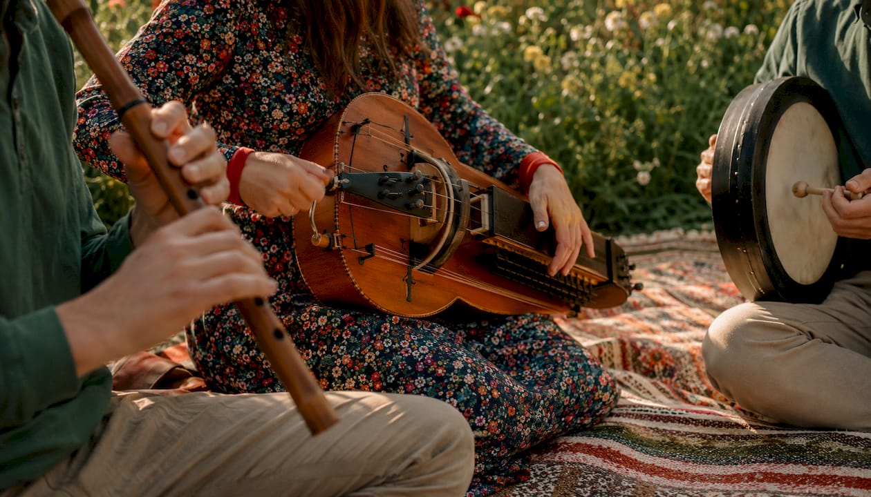 Hands playing traditional European folk instruments
