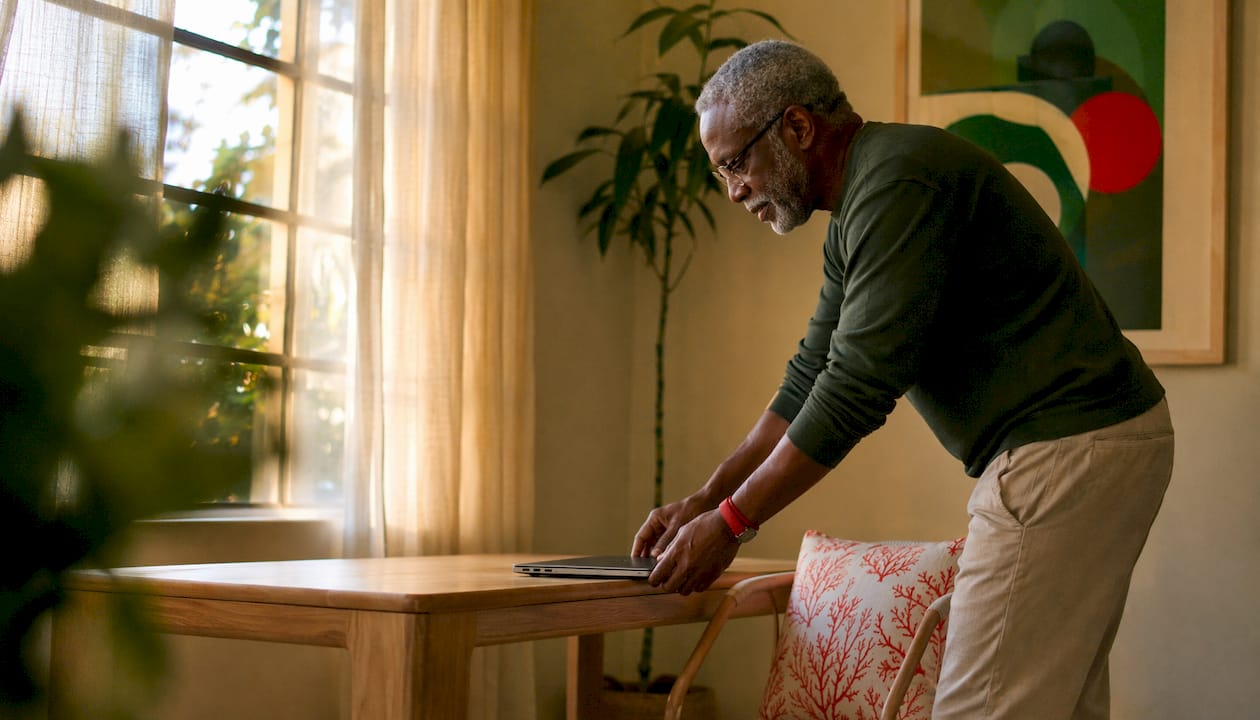 Work From Home Setup Guide: Build Your Best Home Office 2026 Lizard's Lunch Man arranging a quiet home office corner