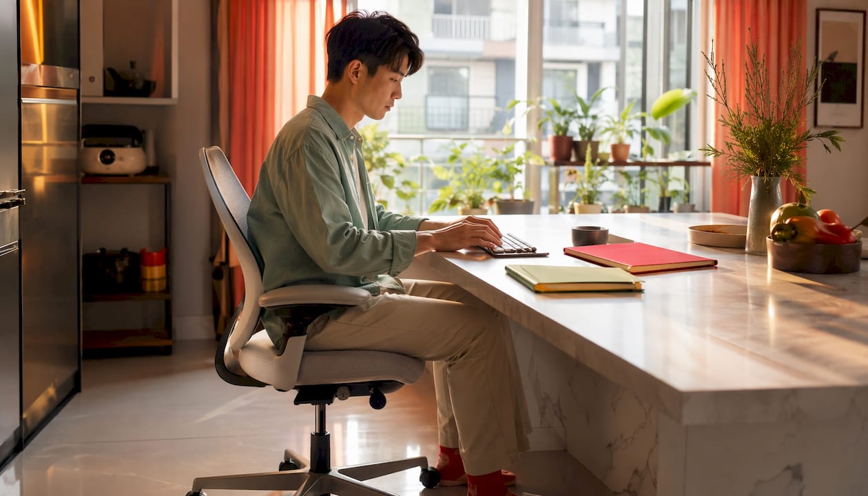 Work From Home Setup Guide: Build Your Best Home Office 2026 Lizard's Lunch Man sitting with proper ergonomic desk posture