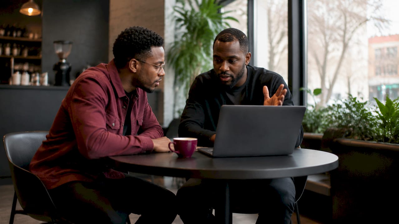 Two HR professionals discussing AI screening results