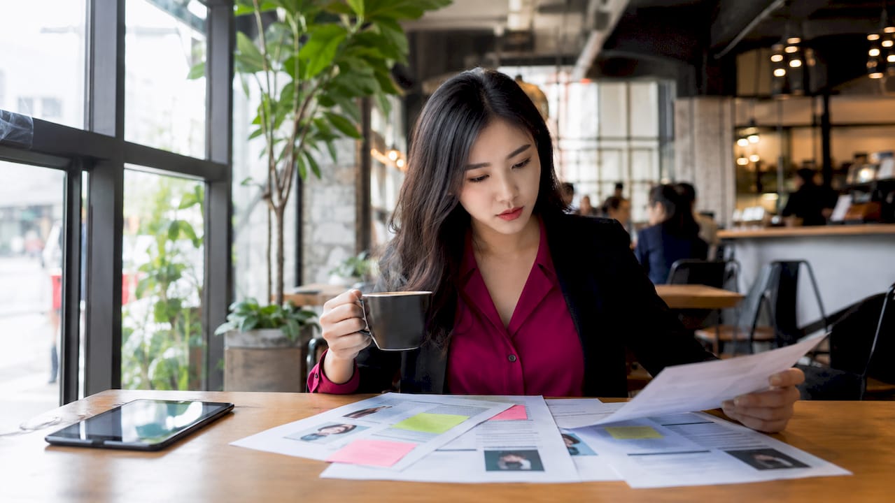HR specialist reviewing candidate profiles at desk