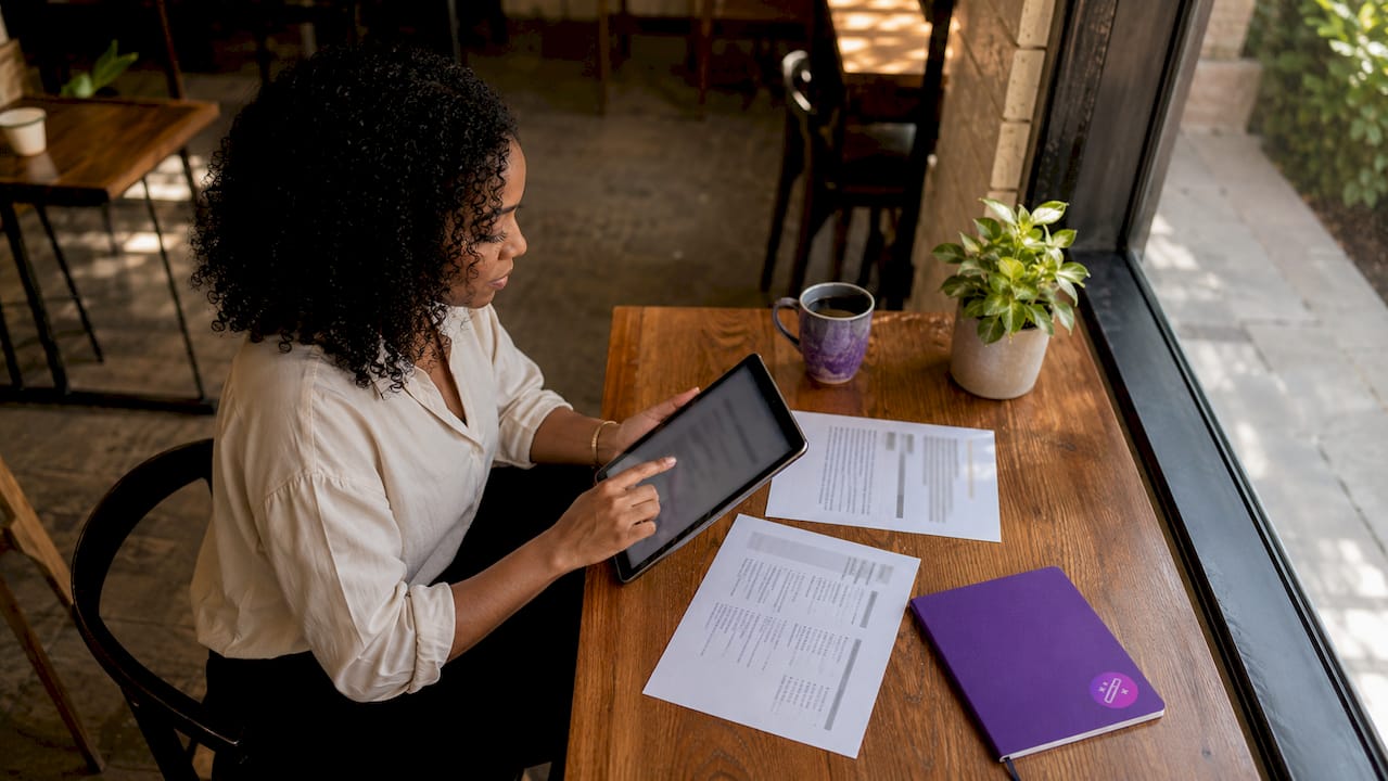 Woman tailoring resume at home office
