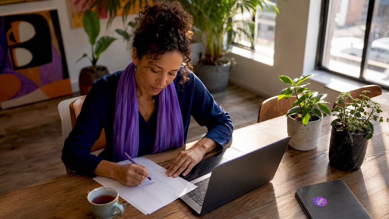 Woman updating skills inventory at desk