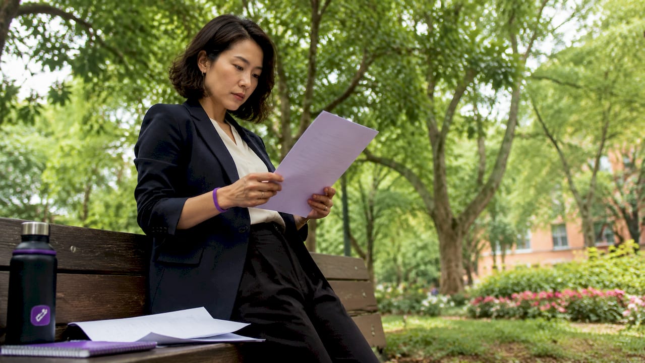 Recruiter reviewing printed resume closely