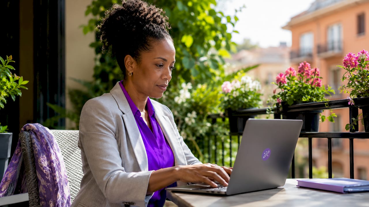 Woman typing on laptop in home office