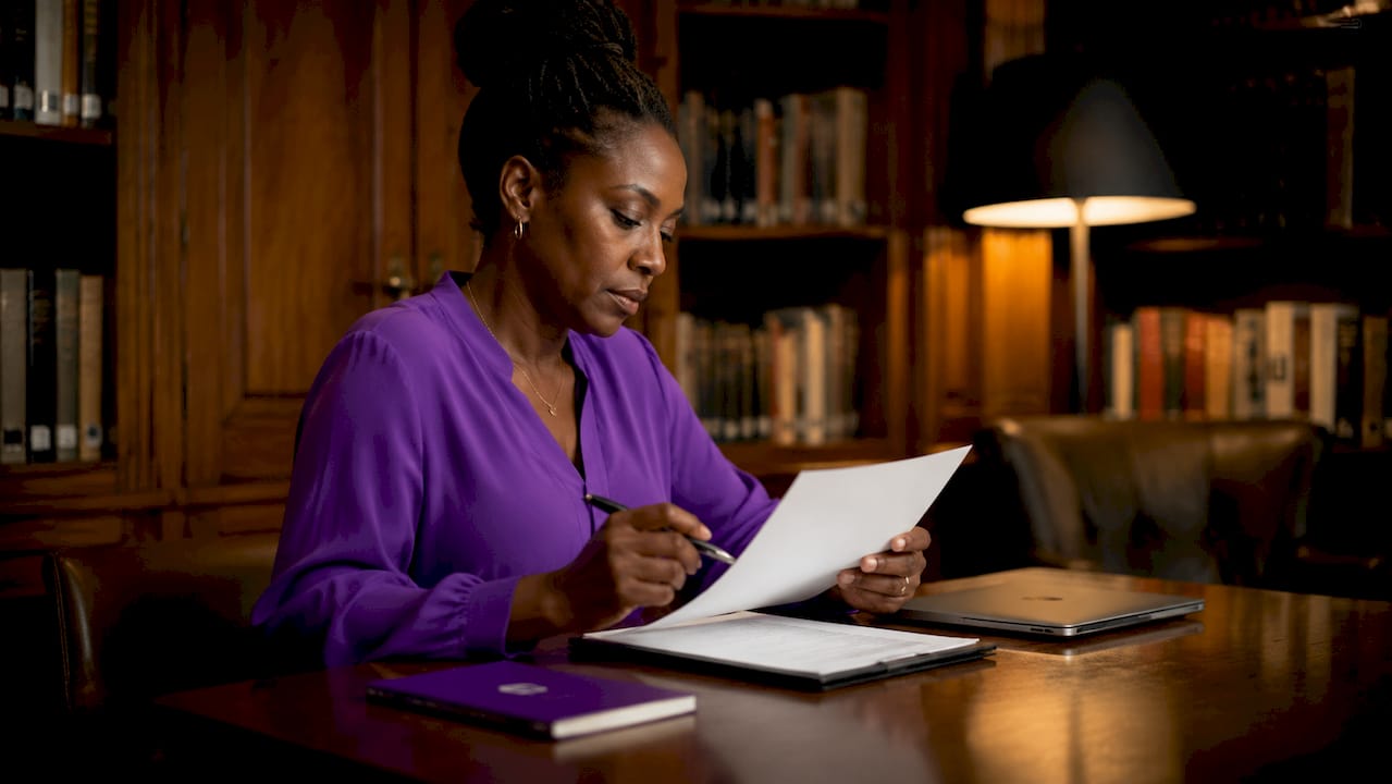 Woman reviewing resume at desk