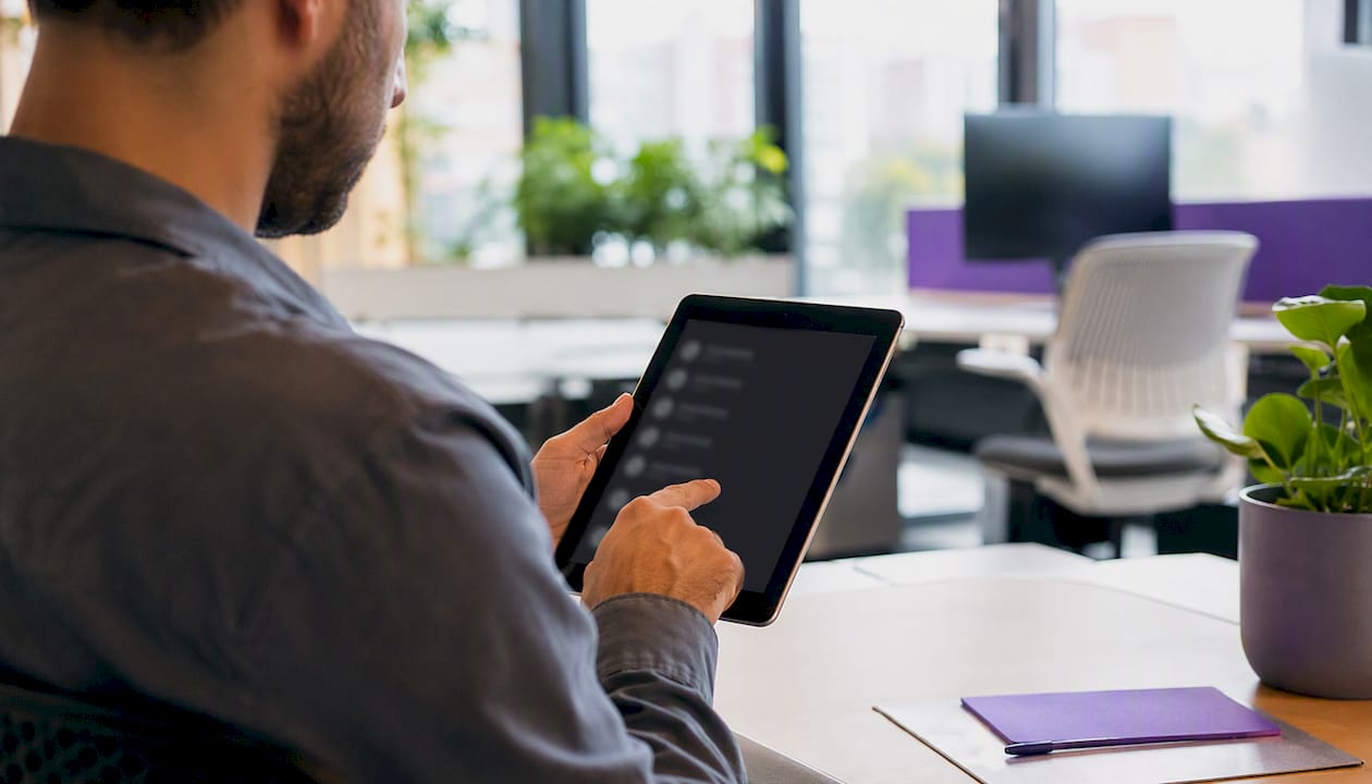 Hands scanning keyword list on tablet
