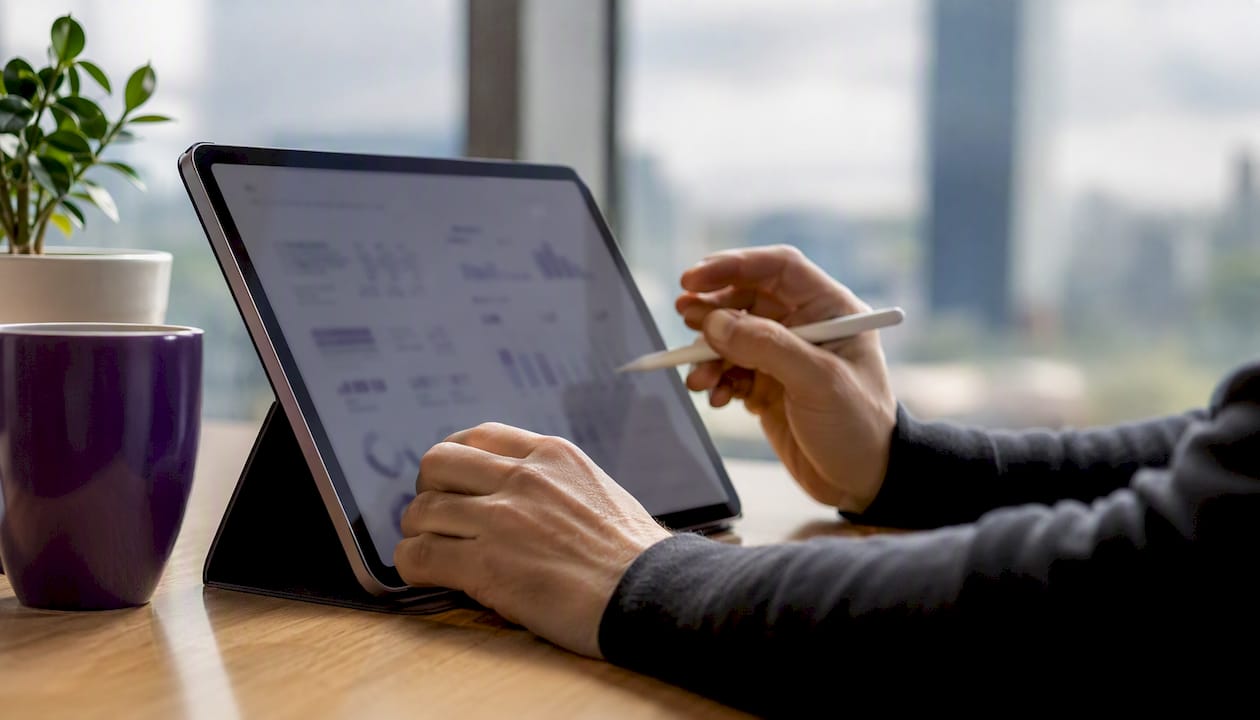 Hands preparing metrics-focused pharmaceutical sales resume