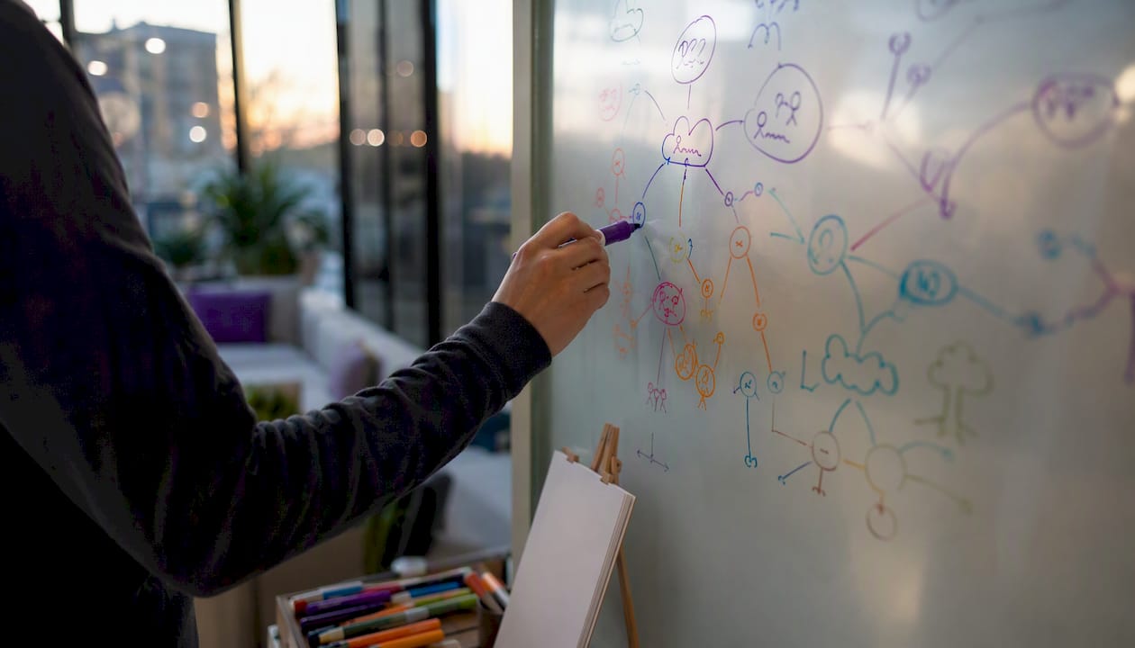 Hands sketching abstract mind map connections