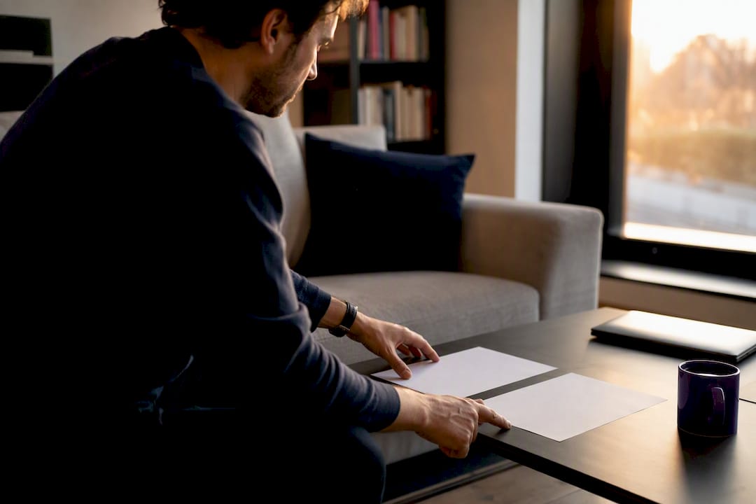 Hands comparing two laptops side by side