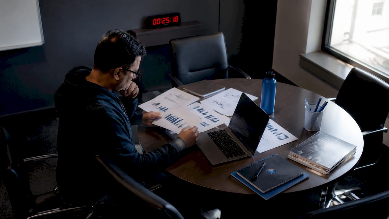 Cybersecurity analyst reviewing SSL certificates at desk